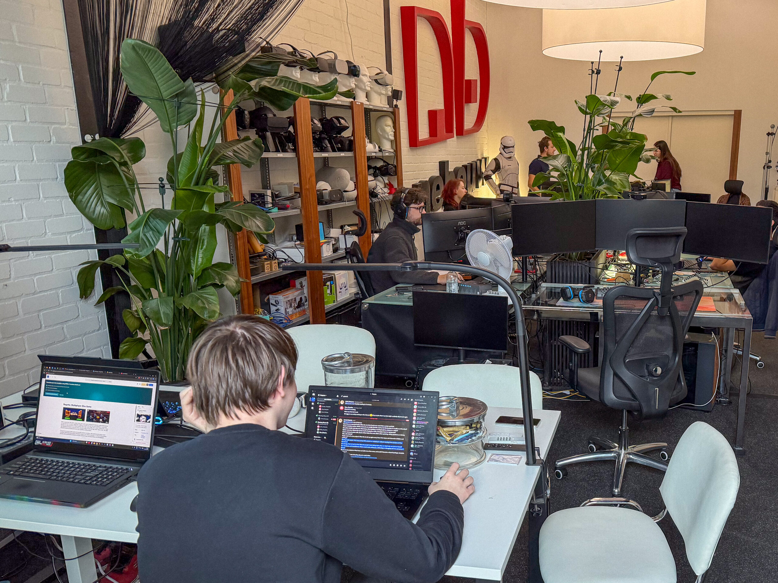 The Easysee development studio during Tooling Day, with developers working at desks surrounded by monitors and hardware.